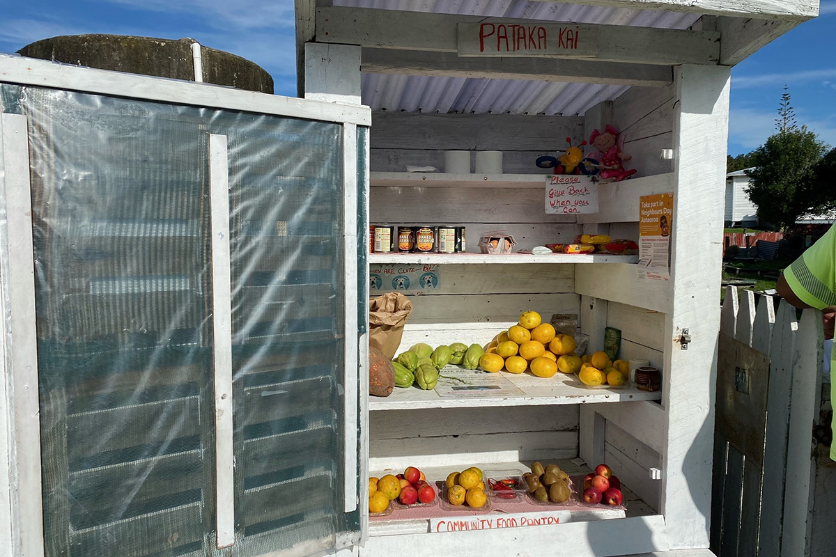 A Pātaka Kai filled with tinned food, fruit and vegetables